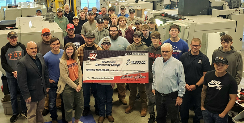 Students in Precision Machining with $15K big check from the Gene Haas Foundation